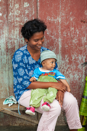 smiling woman with a child on her lap