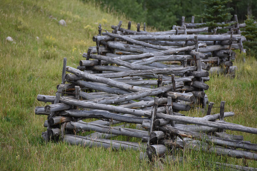 Log fence made in perpendicular sections